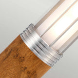 Close-up of the Hornsea 1 Light Bollard in brown, showcasing a teak wood base complemented by a polished stainless steel accent and a frosted cylindrical light shade. This design merges natural and modern elements, providing a soft, warm glow ideal for outdoor lighting.