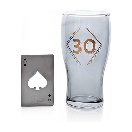 Tulip-shaped blue-tinted beer glass with gold "30" in a geometric diamond design, paired with a stainless steel ace of spades bottle opener on a white background.