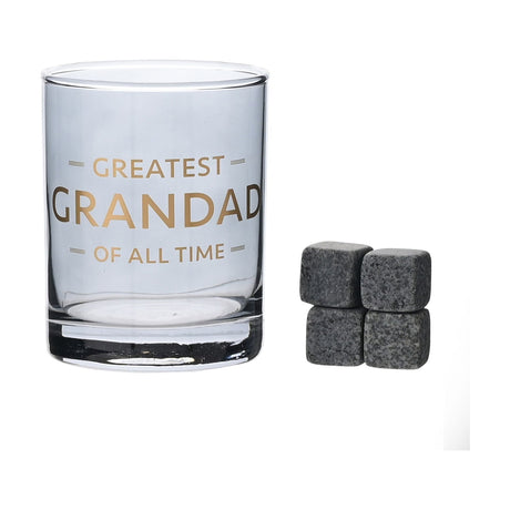 Blue-tinted glass whiskey tumbler with gold "GREATEST GRANDAD OF ALL TIME" text, straight-sided shape with thick clear base, shown with four grey whiskey stones on a white background.
