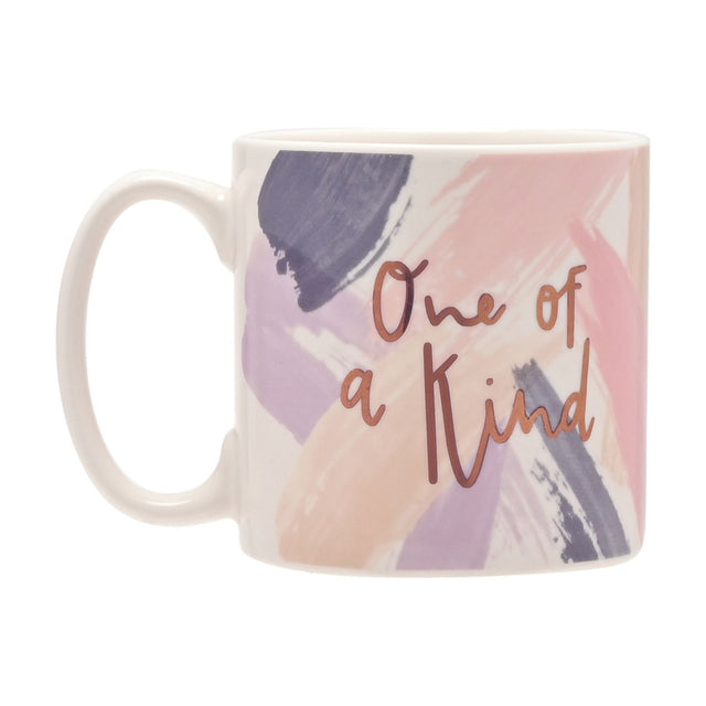 White porcelain mug with blush pink, lilac and slate grey brushstroke design, featuring "One of a Kind" in rose gold script, shown on a plain white background.