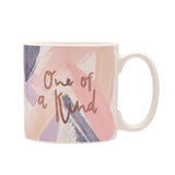 Porcelain mug with "One of a Kind" in rose gold script over blush pink, lilac and slate grey brushstrokes on a white ground, shown on a plain white background.