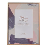 Rectangular metal photo frame with a slim rose-gold edge, featuring a pastel pink, lilac and grey brushstroke mount around a 6 x 4in photo opening.
