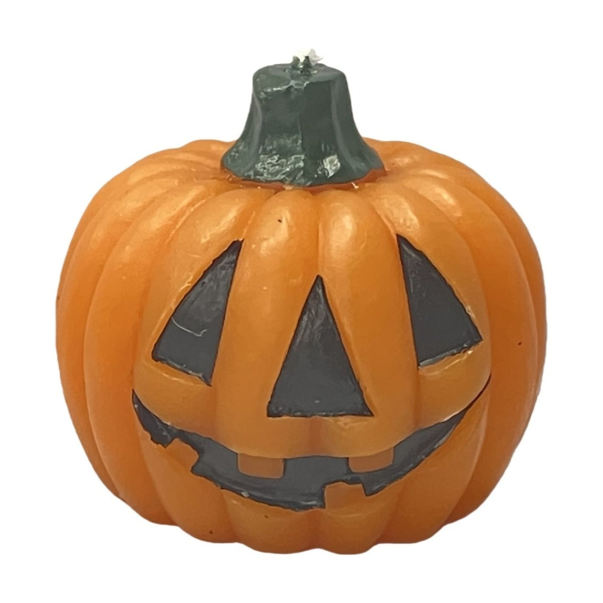 Round orange pumpkin candle, 7cm, with debossed black jack-o'-lantern face and a dark green stem wick, shown on a plain white background.
