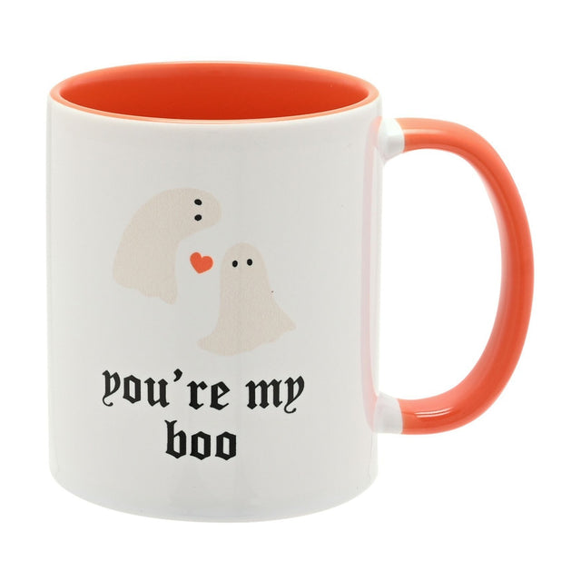 White stoneware mug with orange interior and handle, printed with two ghosts, a heart, and "you're my boo" in black gothic script, on a plain white background.