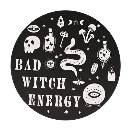 Round matt black ceramic coaster printed with "Bad Witch Energy" in white, surrounded by witchy motifs including a skull, eye, potion bottles, snake, key and crystal ball.
