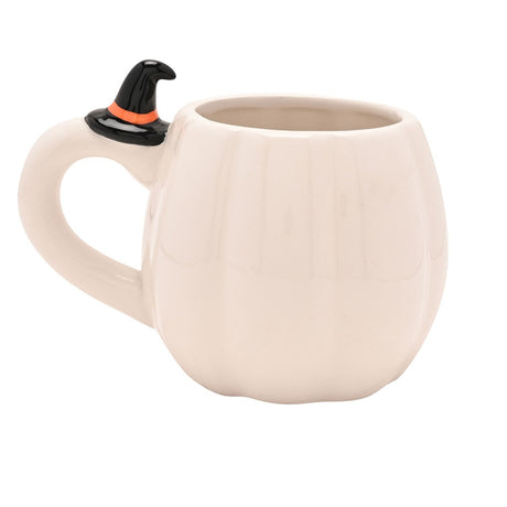 White pumpkin-shaped stoneware mug with ribbed sides, a loop handle topped with a tiny black witch's hat, shown against a plain white background.