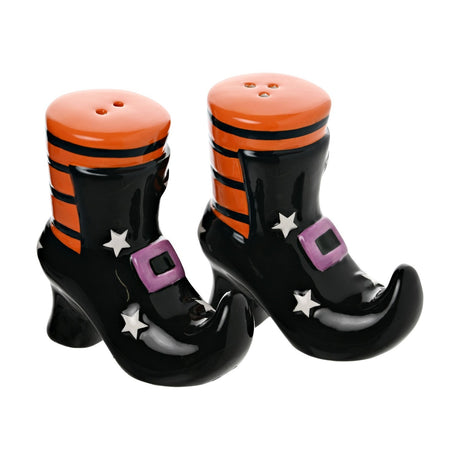 Ceramic salt and pepper set shaped as black witch's boots with curled toes, orange-striped tops, purple buckles and white stars, on a white background.