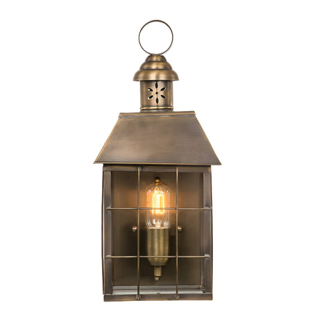 The Hyde 1 Light Outdoor Wall Light in Aged Brass offers a vintage touch with its glass cover and grid pattern. It emits a warm glow when illuminated and includes a loop on top for hanging, bringing timeless charm to any setting.