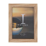 Rectangular freestanding photo frame in light oak wood with visible grain, flat border and inner step, holding a 4 x 6in landscape photo, on a plain white background.
