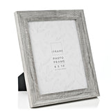 Grey 8x10" photo frame with embossed wood-effect finish and wide stepped rectangular moulding, shown on its rear easel stand against a white background.