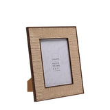 Rectangular 5x7" photo frame with rattan effect natural woven border, mitred corners, slim dark brown edging, and rear stand, shown at an angle on a white background.