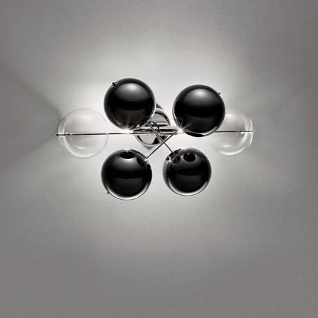 Atom 2 Light Glass Globe Wall Light in chrome, featuring six glass globes—two clear and four black—on a crossed metal frame against a plain grey background.