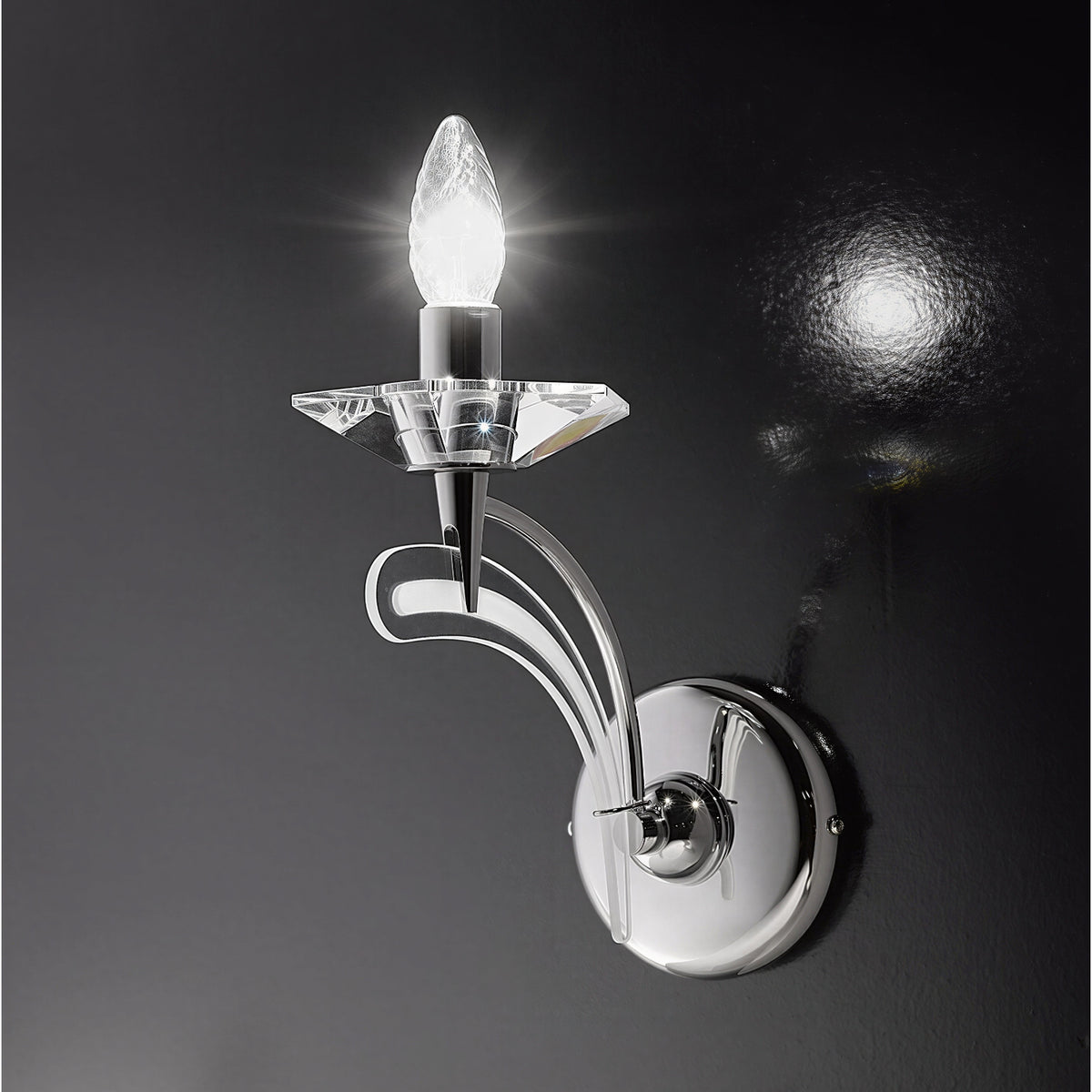 Icaro 1 Light Glass Wall Light with curved chrome arm, faceted crystal bobeche and single lit E14 candle bulb, shown against a dark background.