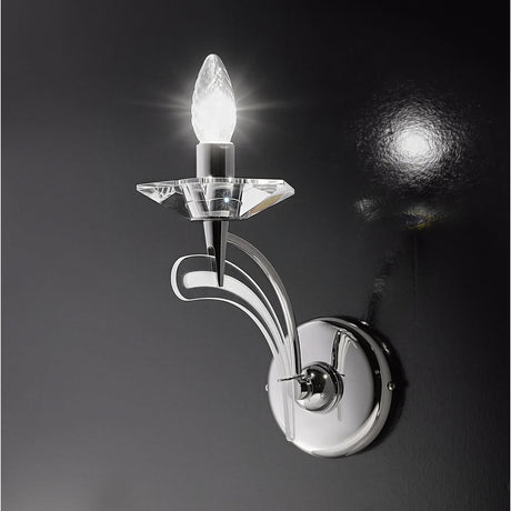 Icaro 1 Light Glass Wall Light with curved chrome arm, faceted crystal bobeche and single lit E14 candle bulb, shown against a dark background.
