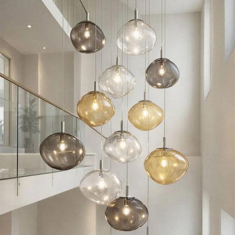 Saxa 35cm Glass Pendant Lights in clustered multi-drop arrangement with organic ribbed shades in clear, grey, amber and chrome finishes, shown over a staircase landing.