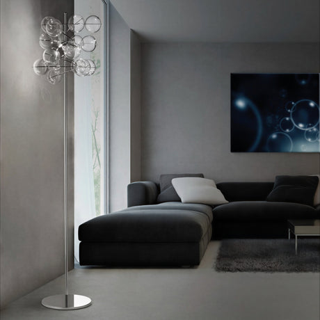Atom 3 Light Globe Glass Floor Lamp with clustered clear glass bubbles on a slim chrome stand, shown in a modern living room beside a dark grey sofa.