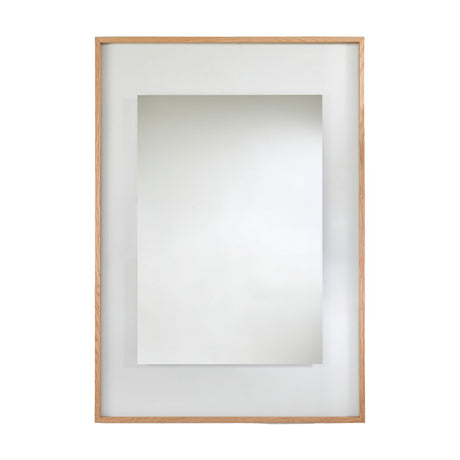 Rectangular mirror in a solid oak frame with a wide partly transparent border around the mirrored centre, on a plain background.