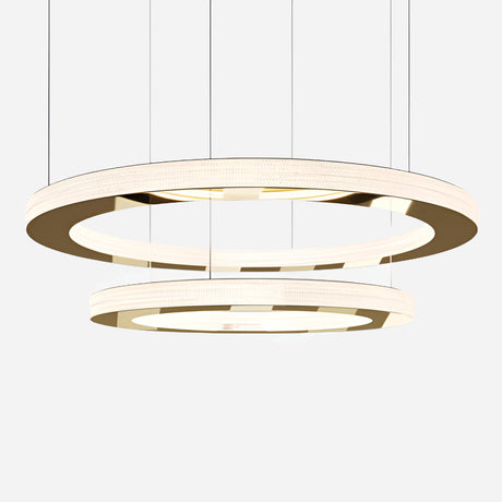 The Celine LED Double Suspension Light - Gold showcases two circular, gold-rimmed LED rings elegantly suspended by wires against a minimalist white backdrop. The design layers the smaller ring beneath the larger one, creating a soft white glow with a sophisticated gold finish.