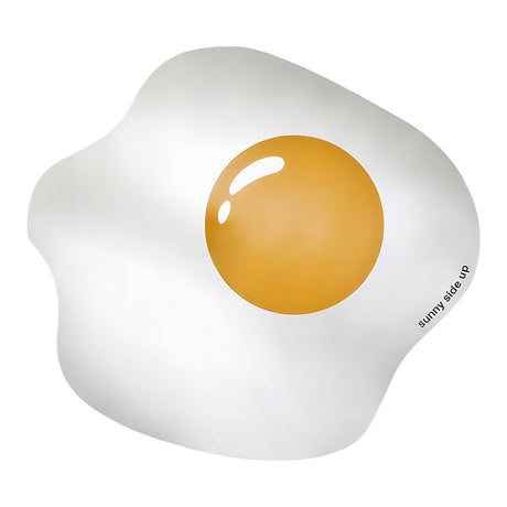 Frameless glass wall mirror shaped like a fried egg, with a printed orange yolk and "sunny side up" text, on a plain white background.