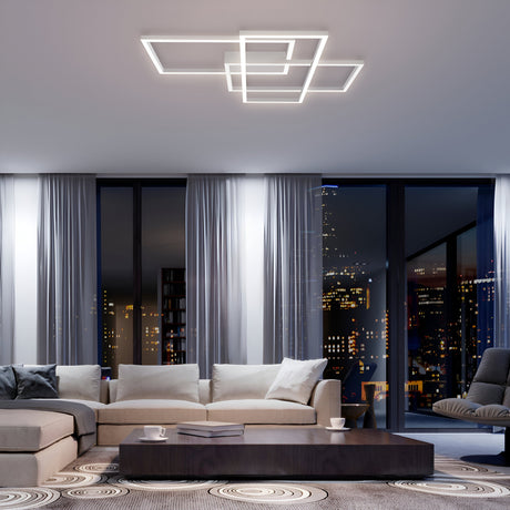 Modern living room with city skyline views, featuring a beige sectional sofa, low dark coffee table, and circular patterned rug. The Rida LED Flush Ceiling Light - White provides energy-efficient lighting for a cozy atmosphere.