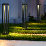 The outdoor garden path is beautifully illuminated by Royal Mile LED Long Rectangular Pedestal Lights in a chic grey design. These IP65-protected lights brighten the green grass and concrete walkway, creating a peaceful evening ambiance.