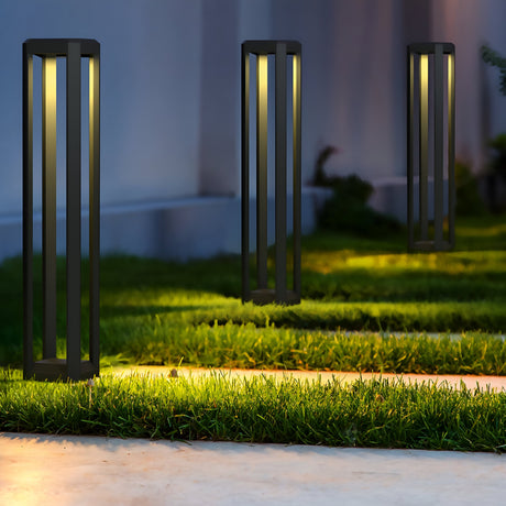 The outdoor garden path is beautifully illuminated by Royal Mile LED Long Rectangular Pedestal Lights in a chic grey design. These IP65-protected lights brighten the green grass and concrete walkway, creating a peaceful evening ambiance.