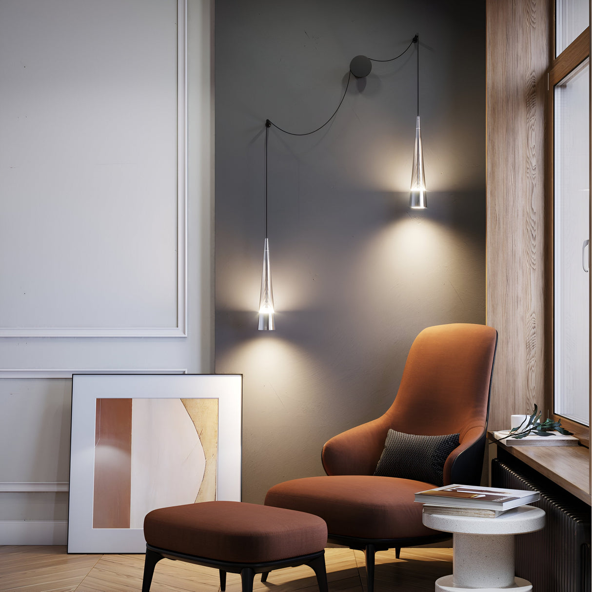 A cozy corner boasts a burnt orange armchair and ottoman, a side table, and chrome Sintesi LED bidirectional wall lights. An abstract art piece leans against the wall, complemented by natural light streaming through a large window.