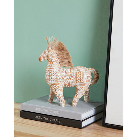 Ishikari horse ornament, a polyresin standing horse figurine with white, gold and brown geometric patterning and fibrous mane, displayed on stacked books near a framed mirror.