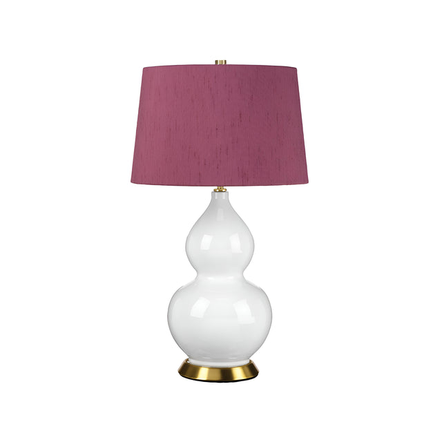 The Isla 1 Light Table Light in White/Purple boasts a curvy base alongside a gold accent at the bottom, complemented by a cylindrical, textured deep pink lampshade. Set against a plain white background, its elegant design ensures it stands out as an eye-catching piece in any room.