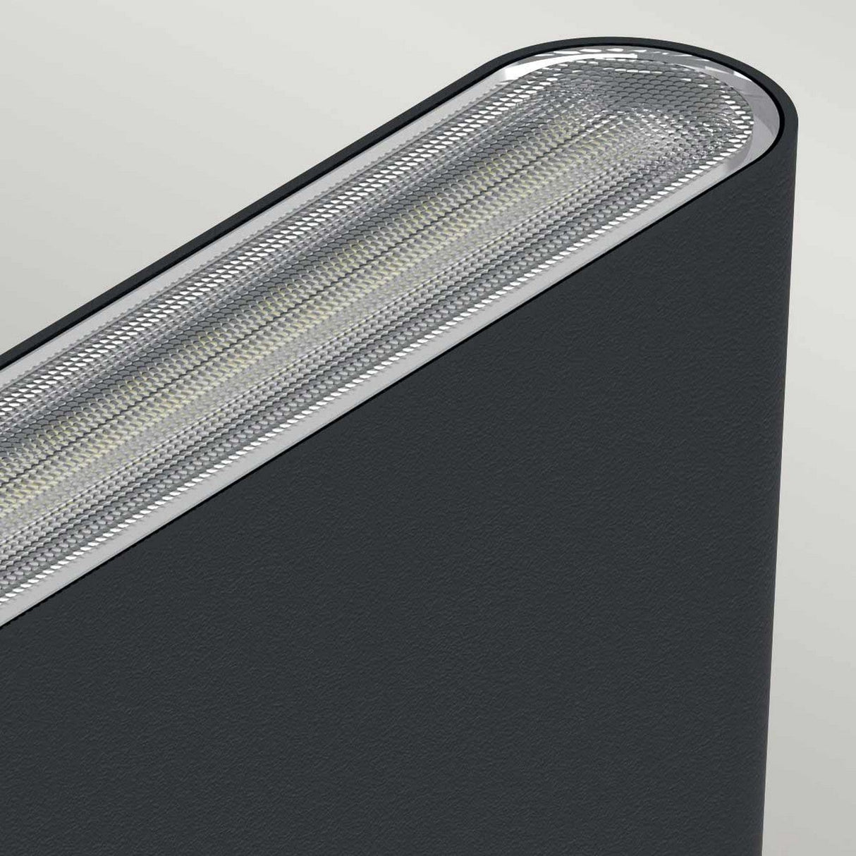 Close-up of the Jens-1 LED Outdoor Wall Light in black, featuring a modern and sleek elliptical design with a textured metallic edge and an LED light strip along the top. This IP65-rated fixture, set against a neutral background, promises durability and offers adjustable color temperature for versatile illumination.