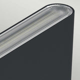 Close-up of the Jens-1 LED Outdoor Wall Light in black, featuring a modern and sleek elliptical design with a textured metallic edge and an LED light strip along the top. This IP65-rated fixture, set against a neutral background, promises durability and offers adjustable color temperature for versatile illumination.