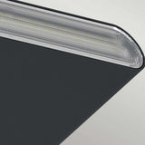 Close-up of the Jens-1 LED Outdoor Wall Light in black, featuring a modern metallic object with a smooth, dark surface and a textured silver edge. Its minimalist design is contemporary and rated IP65 for durability.