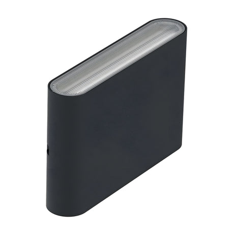 A Jens-2 LED Outdoor Wall Light in black showcases a sleek design with a rectangular shape, rounded edge, and textured top surface reminiscent of die-cast aluminum, complete with a visible LED light on the side that ensures modern functionality while preserving its stylish aesthetic.