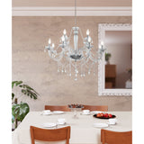 Joressa Clear Glass 12 Light Pendant in chrome finish with twisted glass arms and hanging crystal drops, shown above a dining table in a neutral-toned room.