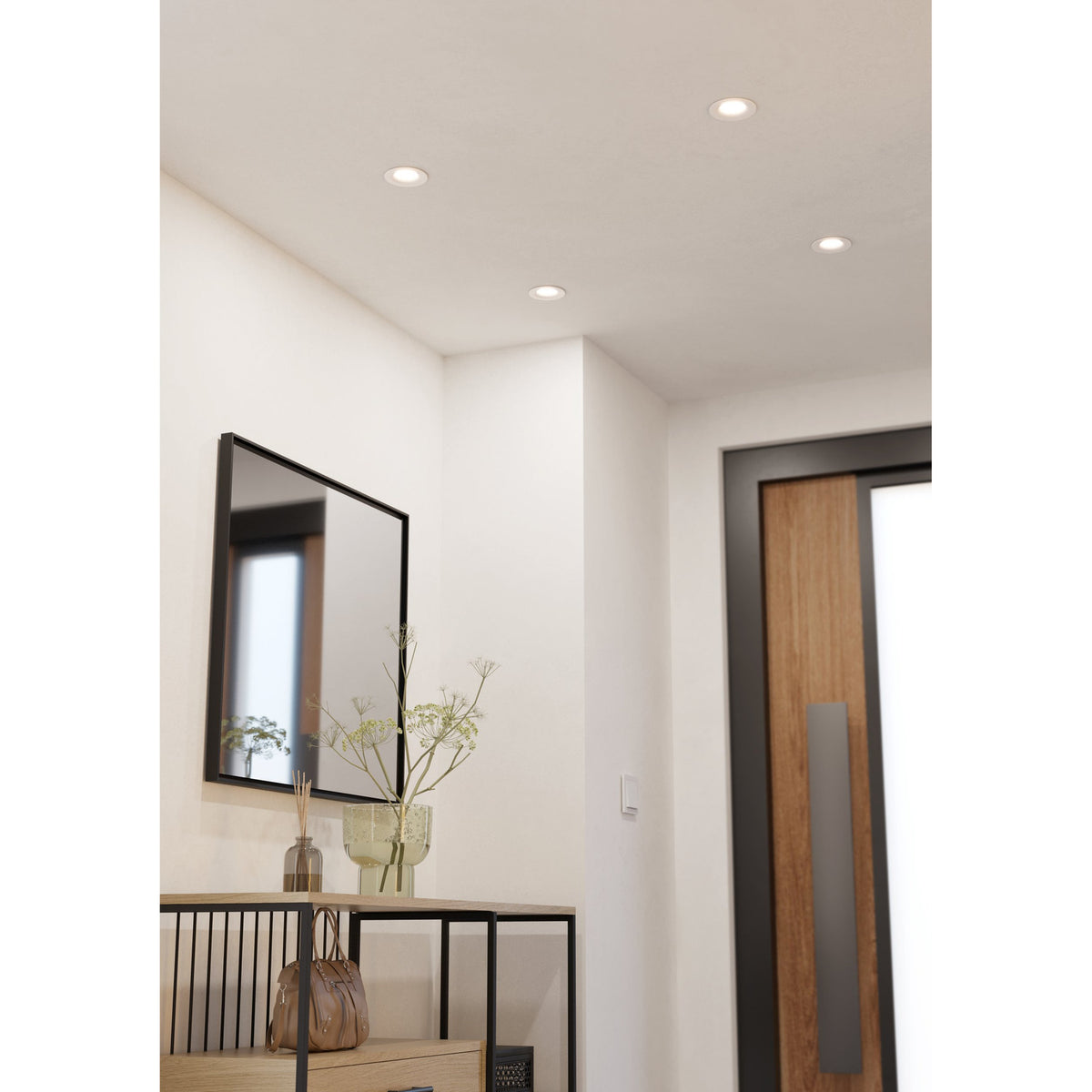 Kamarne LED Downlight 8.8cm in white, recessed into a hallway ceiling, shown alongside wall mirror, console table and front door in a lifestyle setting.