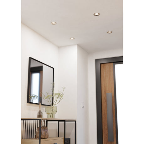Kamarne LED Downlight in satin nickel, 8.8cm round recessed fittings shown installed in a hallway ceiling near a wall mirror and entrance door.