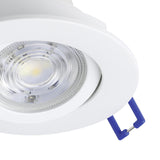 Close-up of the Kamarne white LED downlight with round aluminium body, tilting centre, clear lens detailing and blue connector wires, set against a plain background.