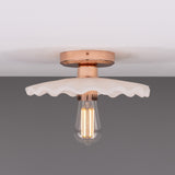Kapok ceramic ceiling light with a scalloped, ribbed matt white shade, copper lampholder and ceiling plate, and exposed filament bulb, shown against a plain grey background.