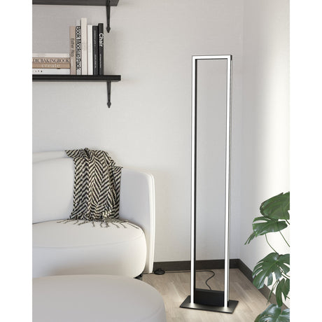 Kelbarne Smart LED Floor Lamp in black, a tall open rectangular frame with illuminated edges on a flat base, shown in a living room beside a sofa and shelving.