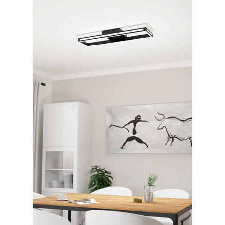 Kelbarne Smart LED Flush Ceiling Light in black, a rectangular frame fixture mounted close to the ceiling above a dining table in a modern room setting.
