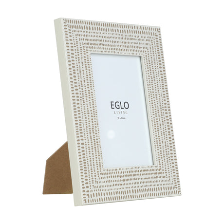 Kemayan Photo Frame in cream with taupe dash and dot patterned border, glass front, holding a 10x15cm photo, shown at an angle with kickstand on a white background.