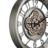 Kenema Wall Clock 46cm, close-up of the round skeleton face showing exposed antique gold gears, silvery grey hub, black hands, and cut-out Arabic numerals on a metal frame.