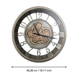 Kenema round wall clock, 46cm, skeleton face with cut-out Arabic numerals, silvery-grey metal frame, exposed antique gold gears at centre, minute track ring, shown against a white background.