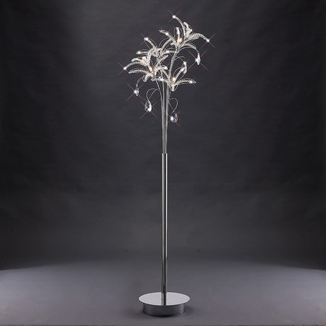 The Kenzo 6 Light Crystal Floor Lamp features a polished chrome base and tree-like, crystal-accented branches, creating a modern and elegant look that stands out beautifully against dark backgrounds.