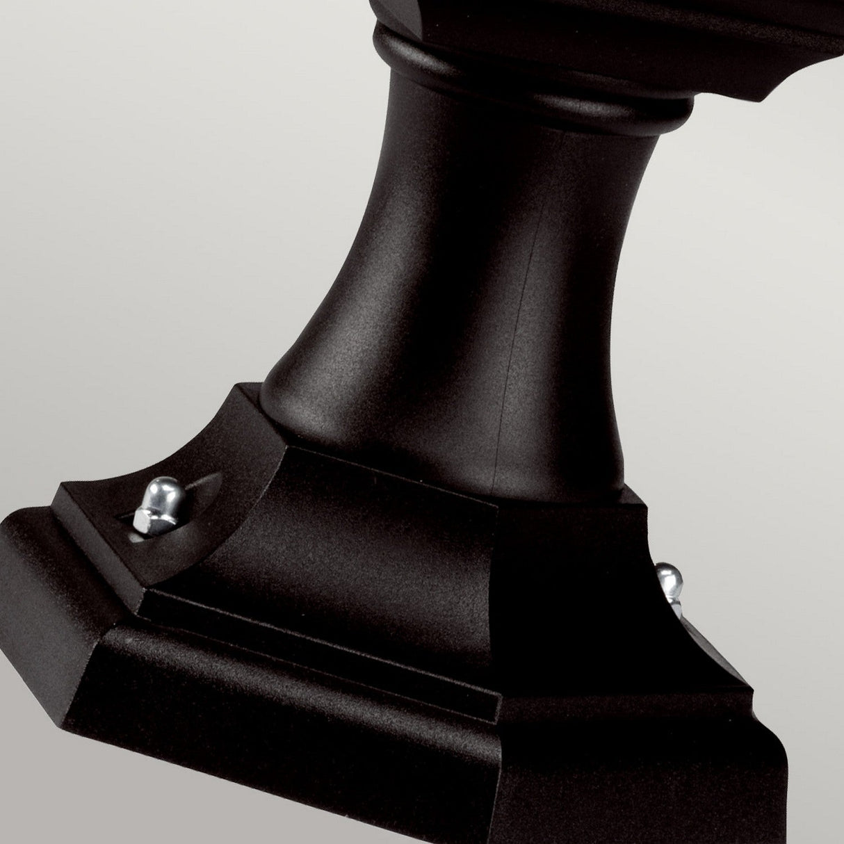 Close-up of the Kerry 1 Light Pedestal/Porch in matte black, featuring elegant curves and decorative bolts, set against a neutral background, perfect for outdoor spaces. Its corrosion-proof design ensures durability and style all year long.