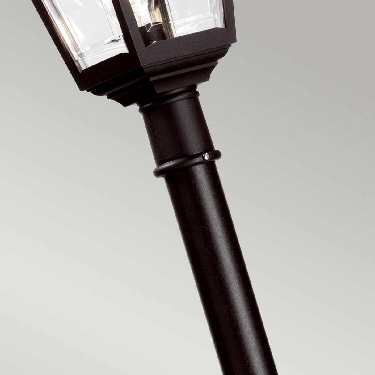 Close-up of the Kerry 1 Light Lamp Post in black, featuring a traditional lantern-style light fixture, designed to be corrosion-proof. The backdrop is a plain, light gray.