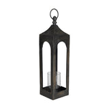 Kerteh Candle Lantern, a tall square aluminium lantern in matte black with arched open sides, a pitched top, hanging ring handle, and a clear glass candle cylinder, shown on a white background.