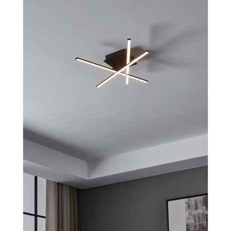 Keselle LED 3 Light Flush Ceiling Light in black, three slim crossing bars mounted on a square ceiling plate, shown illuminated on a grey ceiling in a room setting.