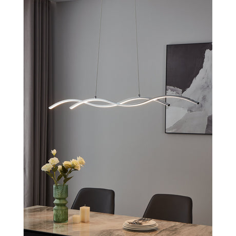 Keselle 120cm LED pendant light with two intertwined wavy chrome bars and white integrated shades, suspended on twin wires above a dining table in a living room setting.