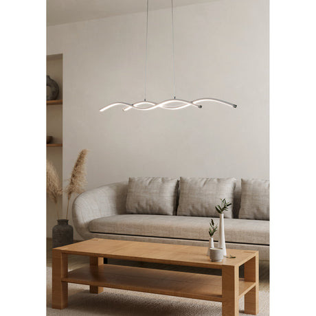 Keselle Pendant Light 87cm in chrome, two wavy intertwined LED bars suspended from thin wires, shown above a coffee table in a living room with a grey sofa.
